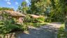 View of front of home with driveway and brick.