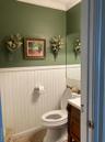 Bathroom featuring wainscoting, vanity, and ornamental molding