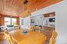 Dining room with wood ceiling, a fireplace, wood finished floors, and ceiling fan
