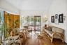 Inviting living area showcasing rich wood-finished floors and a soaring cathedral ceiling.