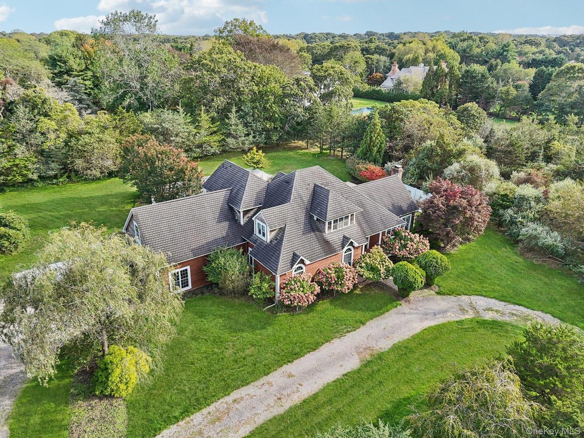 A stunning aerial view showcasing the property’s impressive front elevation and architectural presence.