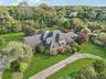 A stunning aerial view showcasing the property’s impressive front elevation and architectural presence.