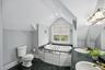 Luxurious primary bath showcasing a whirlpool jetted tub, ambient recessed lighting, a double vanity, and an e-steam shower for a spa-like experience.