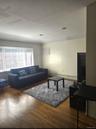 Living area with dark wood-style floors and a baseboard radiator