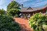 Side patio with Wisteria covered pergola