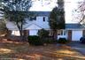 View of front of house featuring brick siding, an attached garage, and driveway