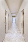 Corridor featuring marble finish floor and recessed lighting