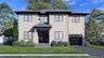 View of front of home featuring a shingled roof, a garage, stucco siding, and driveway
