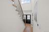 Doorway to outside featuring stairs, wood finished floors, recessed lighting, and a high ceiling