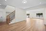 Unfurnished living room featuring recessed lighting, light wood-type flooring, stairway, and crown molding