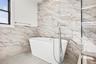 Full bathroom featuring a soaking tub