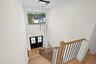 Staircase featuring wood finished floors, french doors, a towering ceiling, and recessed lighting