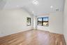 Empty room featuring light wood-type flooring, lofted ceiling, and recessed lighting