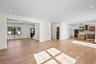 Unfurnished living room with recessed lighting, light wood finished floors, and stairway