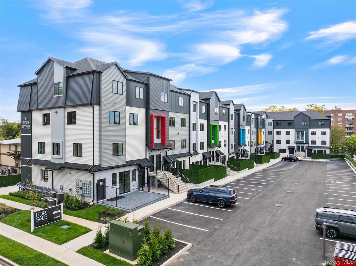 View of property with a residential view and uncovered parking