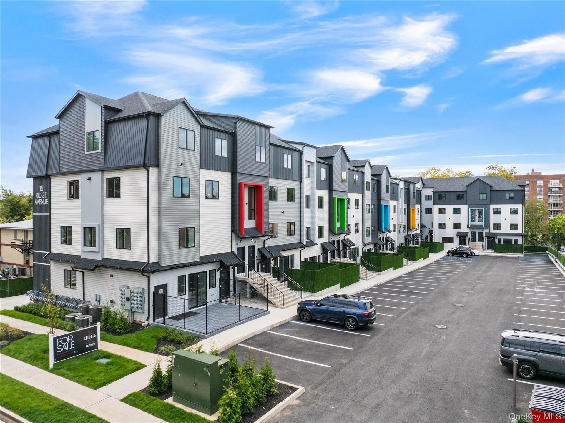 View of property with a residential view and uncovered parking