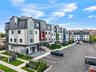 View of property with a residential view and uncovered parking