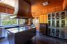 Kitchen featuring island exhaust hood, wood ceiling, wooden walls, a kitchen island, butcher block countertops, butlers pantry