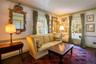 Sitting room with wood floors, baseboards, and ornamental molding