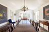 Formal Dining room with a chandelier, vaulted ceiling, wood floors