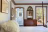 Bedroom with ornamental molding and connected bathroom