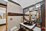 Ensuite bathroom with tile walls and vanity
