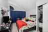 Bedroom featuring lofted ceiling, a textured ceiling, light colored carpet, and a closet