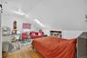 Bedroom featuring a skylight, hardwood / wood-style flooring, and vaulted ceiling