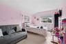 Bedroom featuring tile patterned floors, a textured ceiling, lofted ceiling, a wall unit AC, and a baseboard heating unit