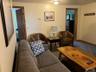 Carpeted living area with baseboards