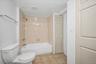 Bathroom with tile patterned floors and shower / bath combination