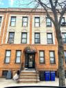 Townhome / multi-family property featuring brick siding
