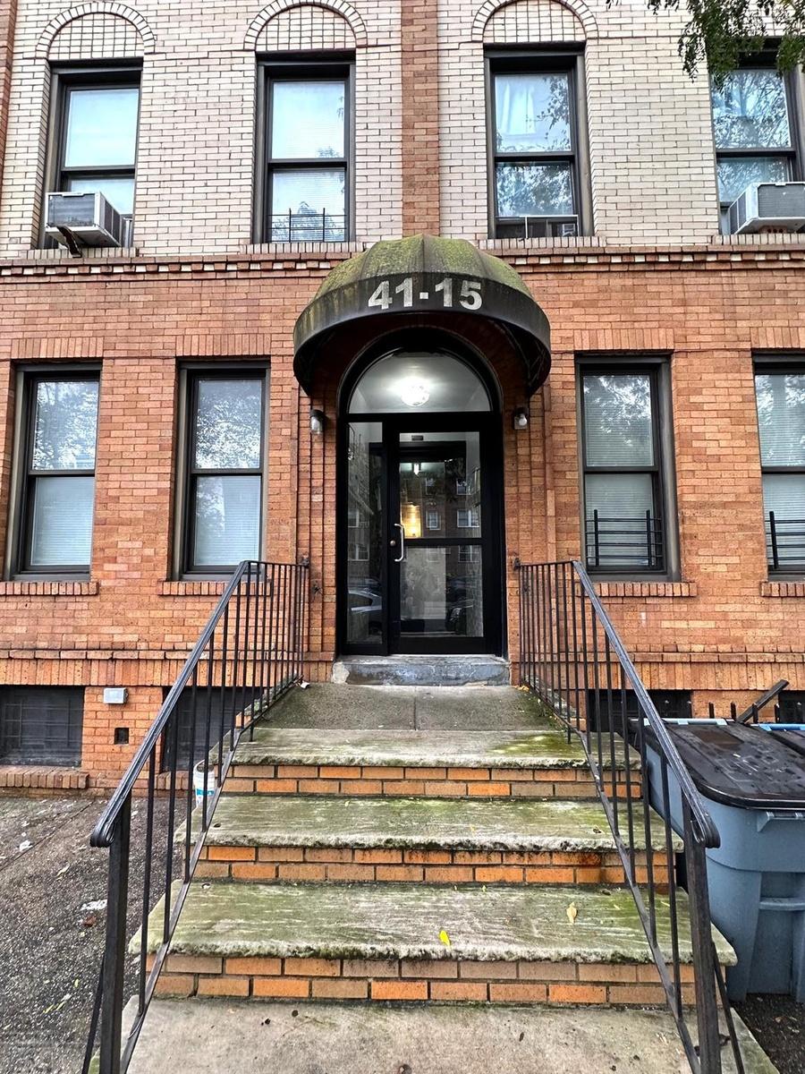 View of exterior entry featuring brick siding