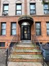 View of exterior entry featuring brick siding