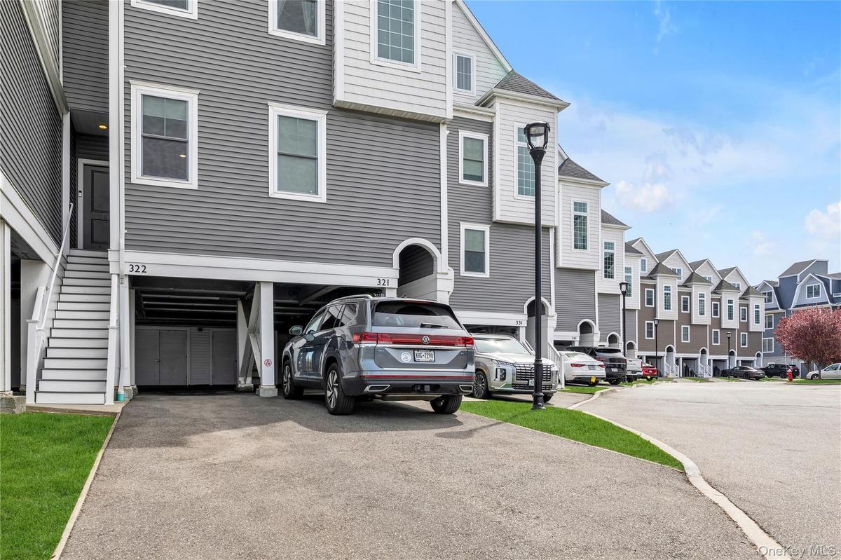 View of front of home with asphalt driveway and a residential view