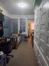 Carpeted bedroom featuring a desk and a textured ceiling