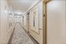 Hallway featuring elevator and carpet