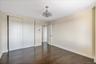 Unfurnished bedroom featuring dark wood finished floors and a closet