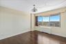 Unfurnished room with dark wood-type flooring and radiator heating unit