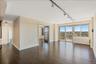Unfurnished room featuring rail lighting and dark wood finished floors
