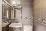Bathroom featuring tile walls, vanity, and backsplash