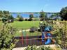 Communal playground featuring a water view