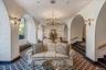 Building lobby featuring a textured wall, stairs, and a textured ceiling