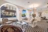 Living room featuring a textured wall, carpet flooring, a textured ceiling, a chandelier, and recessed lighting