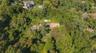 View of property location with a heavily wooded area