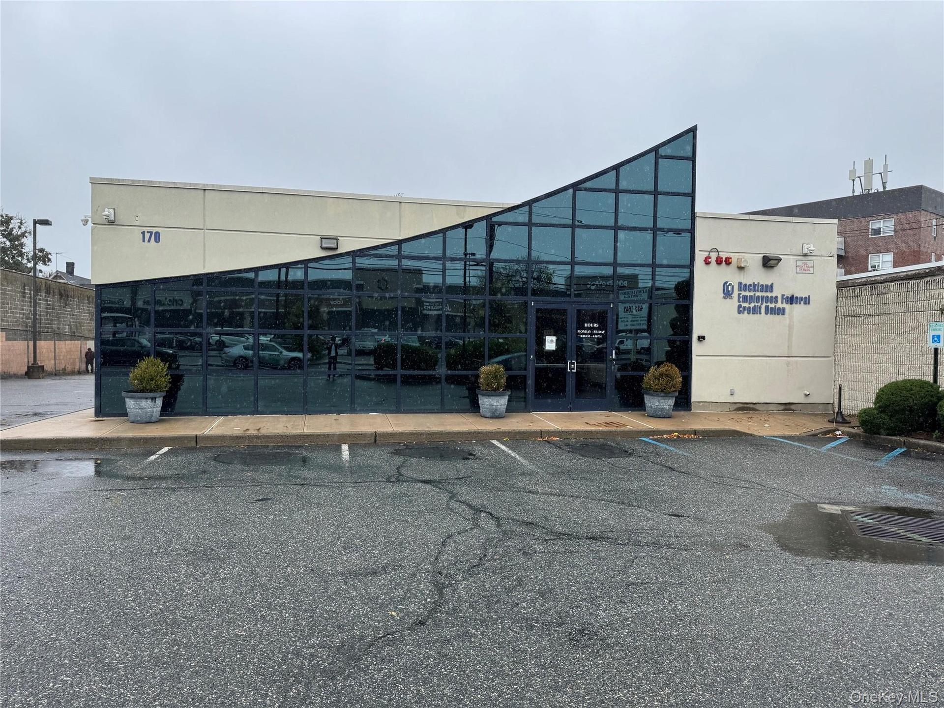 View of building exterior with uncovered parking