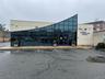 View of building exterior with uncovered parking