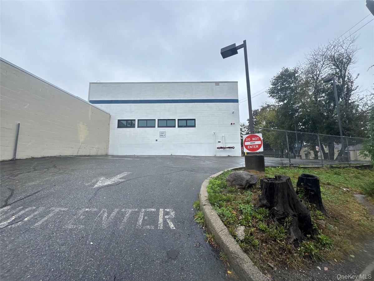 View of building exterior with uncovered parking