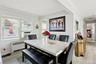 Dining room with crown molding, radiator heating unit, light wood finished floors, and cooling unit