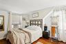 Bedroom with ornamental molding, dark wood-type flooring, cooling unit, and lofted ceiling